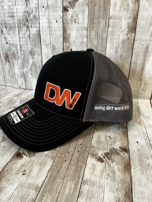 A black and grey colored snapback cap with DW logo
