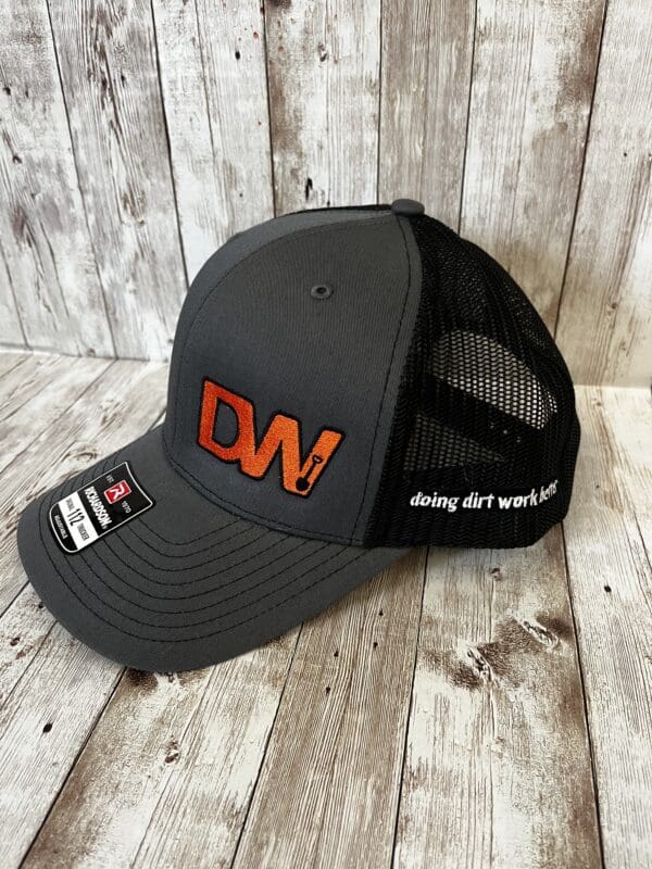 A gray and black hat with an orange logo.