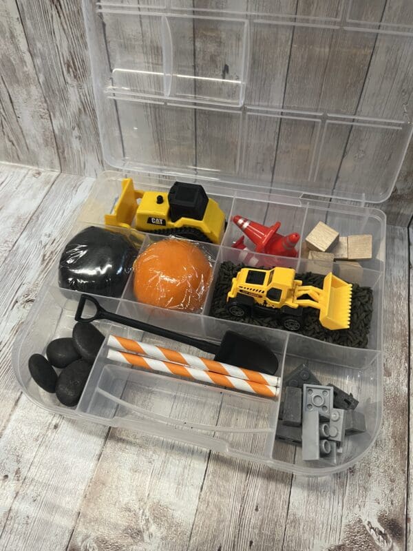 A plastic container filled with construction toys.