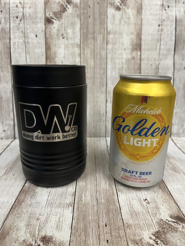 A can of beer and a drink cup on top of a table.