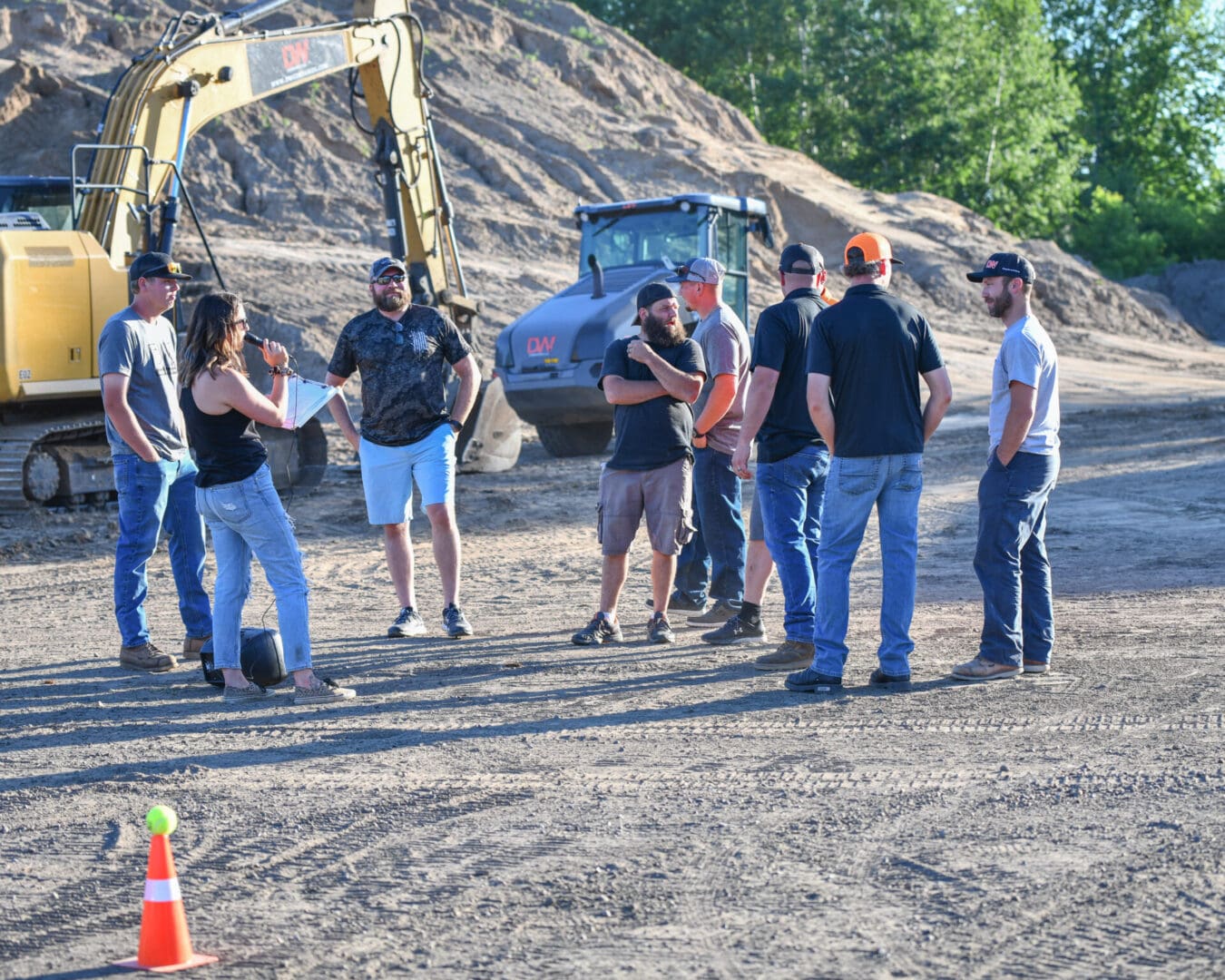 A group of people standing around in front of a construction site.